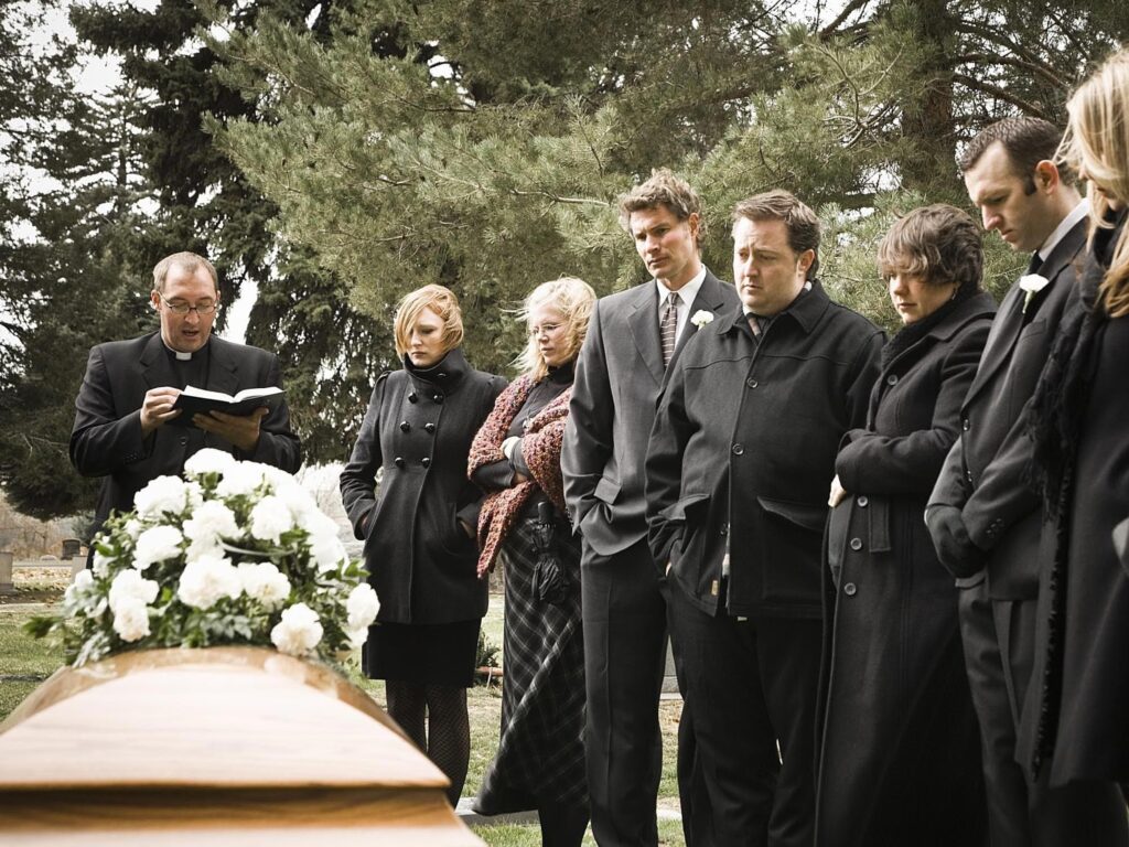 people standing around at a funeral. Seek counselling advice from Dr Amelia Haines today.